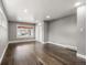 Spacious bedroom with ample natural light, beautiful hardwood floors, and a calming grey paint scheme at 748 W 100Th Ave, Northglenn, CO 80260
