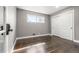 Inviting bedroom with wood floors, sliding door closet, neutral gray walls and bright natural light at 748 W 100Th Ave, Northglenn, CO 80260