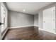 Large bedroom with dark wood floors, a large window for natural light and neutral grey colored walls at 748 W 100Th Ave, Northglenn, CO 80260