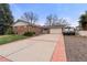 Charming single-story brick home with a spacious driveway and attached two-car garage at 748 W 100Th Ave, Northglenn, CO 80260