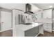 Bright kitchen with white cabinets, stainless steel appliances, and a stylish island with a cooktop at 748 W 100Th Ave, Northglenn, CO 80260