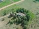 Aerial view of a house surrounded by trees and green grass in a rural setting at 9212 Tanglewood Rd, Franktown, CO 80116