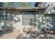 Exterior view of the backyard featuring an entrance with a step up, outdoor lighting, and mature trees providing shade at 9212 Tanglewood Rd, Franktown, CO 80116
