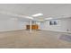 Spacious basement featuring a bar area, carpeted floor, support beam, and natural light from the above ground windows at 9212 Tanglewood Rd, Franktown, CO 80116