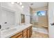 Bathroom featuring double sinks, wood cabinets, tile floor, and glass enclosed shower at 9212 Tanglewood Rd, Franktown, CO 80116