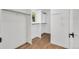 A walk-in closet with hardwood floors, shelving, and ample storage space at 9212 Tanglewood Rd, Franktown, CO 80116