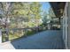 Spacious deck with metal railing overlooking wooded area with mature trees at 9212 Tanglewood Rd, Franktown, CO 80116