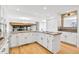 Bright kitchen featuring white cabinets, stainless appliances, and an island with granite counters at 9212 Tanglewood Rd, Franktown, CO 80116