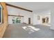 Bright living room with a vaulted ceiling, wood accents, a sliding glass door to the deck, and a staircase at 9212 Tanglewood Rd, Franktown, CO 80116