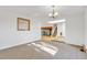 Spacious living room featuring neutral walls, plush carpeting, an open floor plan, and a staircase at 9212 Tanglewood Rd, Franktown, CO 80116