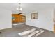 Bright living room featuring neutral walls, plush carpeting, wood accents, and abundant natural light from large windows at 9212 Tanglewood Rd, Franktown, CO 80116