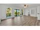 Sunlit living room with hardwood floors, ceiling fan, and glass doors leading to deck at 9212 Tanglewood Rd, Franktown, CO 80116