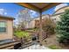 Secluded backyard patio with fence, landscaping, and outdoor seating in a lush backyard at 22310 E Chenango Dr, Aurora, CO 80015