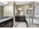 Luxurious bathroom with a soaking tub, double vanity, and modern fixtures at 22310 E Chenango Dr, Aurora, CO 80015