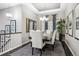Formal dining room with tray ceilings, elegant chandelier, and seating for six at 22310 E Chenango Dr, Aurora, CO 80015