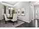 Formal dining room featuring elegant decor and seating for six, bathed in natural light at 22310 E Chenango Dr, Aurora, CO 80015