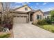 Inviting home exterior with a stone facade, two-car garage and well-maintained front yard at 22310 E Chenango Dr, Aurora, CO 80015