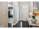 Elegant foyer boasting dark hardwood floors, white trim, and a stylish entryway at 22310 E Chenango Dr, Aurora, CO 80015