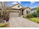 Charming home featuring a stone and stucco facade, large garage, and well-manicured landscaping at 22310 E Chenango Dr, Aurora, CO 80015