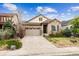 Charming home featuring a stone and stucco facade, large garage, and well-manicured landscaping at 22310 E Chenango Dr, Aurora, CO 80015