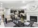 Open concept living room and kitchen with hardwood floors and a fireplace at 22310 E Chenango Dr, Aurora, CO 80015