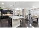 Bright, open-concept living space featuring kitchen island with seating and living area at 22310 E Chenango Dr, Aurora, CO 80015