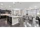 Open-concept living space featuring a modern island and seamless connection to the living area at 22310 E Chenango Dr, Aurora, CO 80015