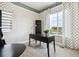 Bright office featuring neutral walls, large window, and a sleek black desk at 22310 E Chenango Dr, Aurora, CO 80015