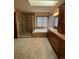 Luxurious bathroom featuring an oversized tiled shower, soaking tub, dual sinks, and skylight at 5151 S Laredo Ct, Centennial, CO 80015