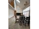 Inviting dining room featuring a fireplace, large windows, and a view of the upper floor loft area at 5151 S Laredo Ct, Centennial, CO 80015