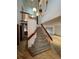Bright and spacious foyer featuring a staircase with wooden banister and chandelier, leading to the upper level at 5151 S Laredo Ct, Centennial, CO 80015