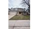Inviting two-story home featuring a brick and siding exterior, complemented by a well-manicured lawn and attached two car garage at 5151 S Laredo Ct, Centennial, CO 80015