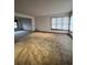 Bright living room featuring neutral carpet and a large window, creating an inviting living space at 5151 S Laredo Ct, Centennial, CO 80015