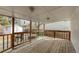 Spacious covered wooden deck featuring views of the backyard and a shed in the distance at 9605 W David Ave, Littleton, CO 80128