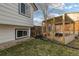 Backyard featuring a unique drive-thru chicken coop and grass area, adding a touch of whimsy at 9605 W David Ave, Littleton, CO 80128