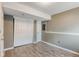 Finished basement area with light gray walls, wood-look flooring, and large closet space for storage at 9605 W David Ave, Littleton, CO 80128