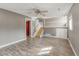 Finished basement with a ceiling fan, stairs to the upper level, and wood plank flooring at 9605 W David Ave, Littleton, CO 80128