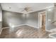 Spacious finished basement with wood plank flooring and a neutrally painted walls at 9605 W David Ave, Littleton, CO 80128