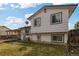 Back exterior view of home featuring a wooden deck, well-maintained yard, and ample natural light at 9605 W David Ave, Littleton, CO 80128