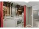 Bright laundry room with modern white washer and dryer units at 9605 W David Ave, Littleton, CO 80128