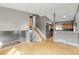 Open-concept living room connects to a kitchen area with wooden cabinets and stainless steel appliances at 9605 W David Ave, Littleton, CO 80128