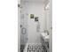 Modern bathroom featuring a glass-enclosed shower, patterned tile floor, and stylish fixtures at 25 S Washington St # 2, Denver, CO 80209