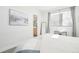 Airy bedroom showcasing a calming coastal artwork, a modern side table, and large mirror for added depth at 25 S Washington St # 2, Denver, CO 80209