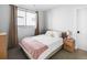 Cozy bedroom with a comfortable bed, soft pink throw, and large window allowing for plenty of natural light at 25 S Washington St # 2, Denver, CO 80209