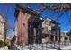 Stunning three-story townhome featuring brick and contemporary design with sleek black accents and a fenced yard at 25 S Washington St # 2, Denver, CO 80209