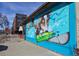 Eye-catching mural of a dog on a blue brick wall adds character to this building exterior at 25 S Washington St # 2, Denver, CO 80209