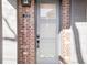 Front door with glass panels, a digital lock, and brick accents at 25 S Washington St # 2, Denver, CO 80209