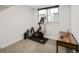 Bright workout room with exercise bike, desk, and large window providing natural light at 25 S Washington St # 2, Denver, CO 80209