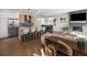 Open-concept living area with modern kitchen, dining space, and cozy living room with fireplace at 25 S Washington St # 2, Denver, CO 80209