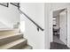 Stairway with light wood steps, a modern black handrail, and an open office space at 25 S Washington St # 2, Denver, CO 80209